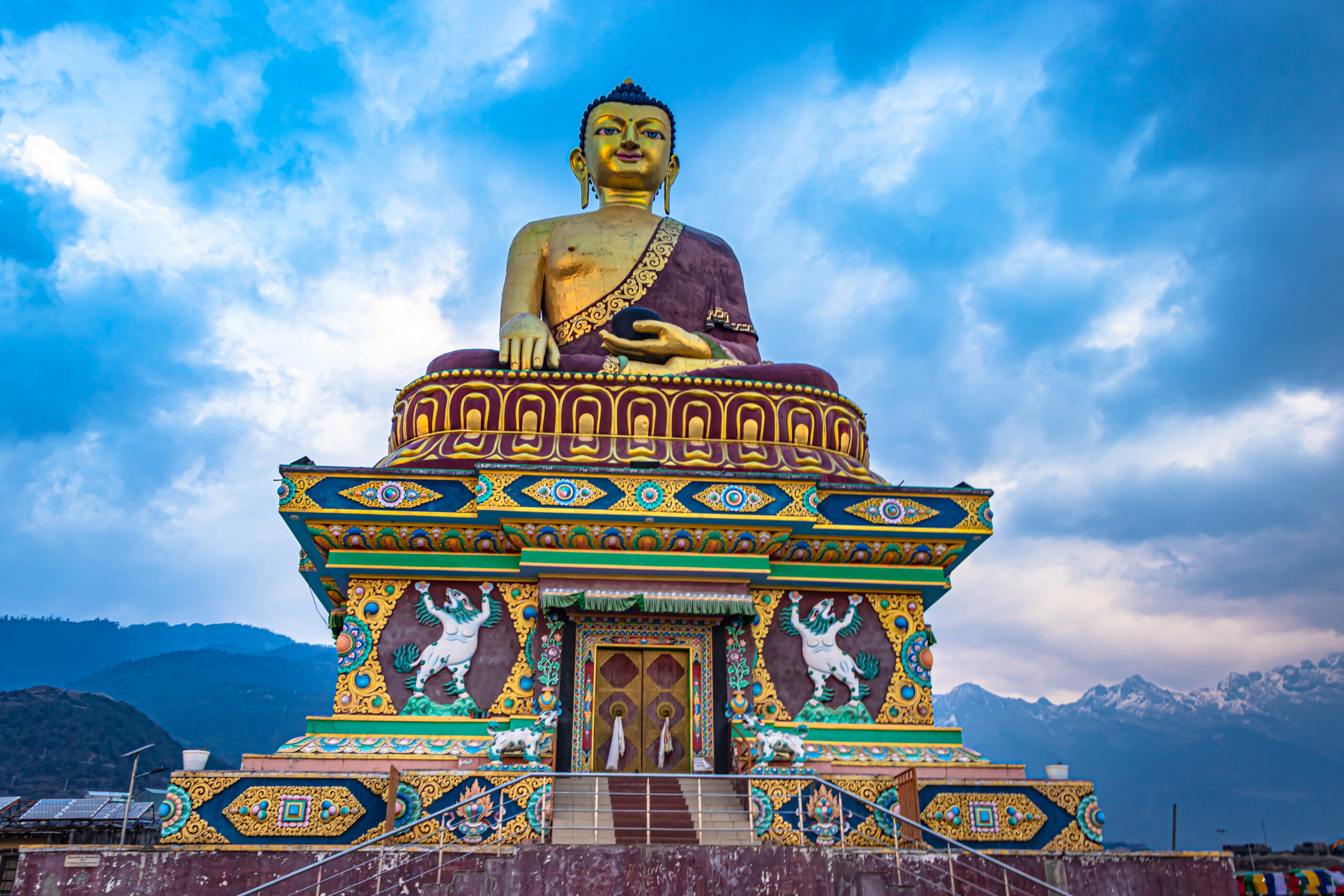 huge buddha golden statue from different perspective with moody sky at evening image is taken at giant buddha statue tawang arunachal pradesh india.