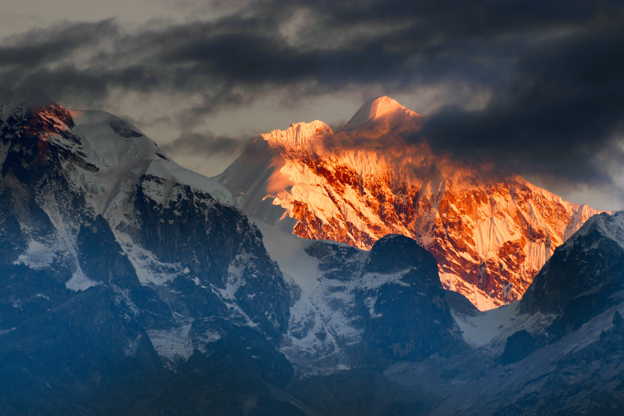 Beautiful first light from sunrise on Mount Kanchenjugha, Himalayan mountain range, Sikkim, India. Orange tint on the mountains at dawn