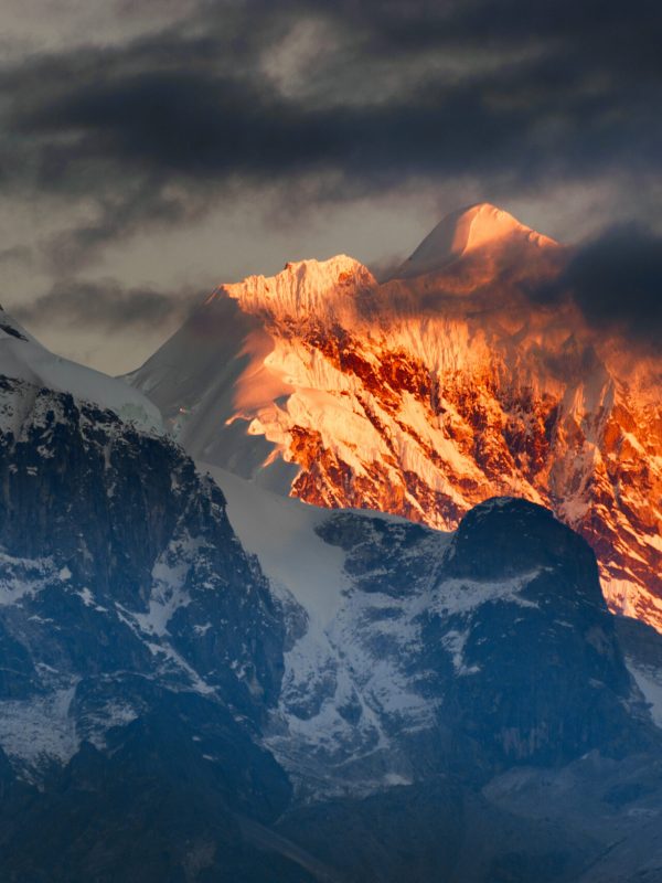 Sunrise on Mount Kanchnejungha, Sikkim, India Beautiful first light from sunrise on Mount Kanchenjugha, Himalayan mountain range, Sikkim, India. Orange tint on the mountains at dawn